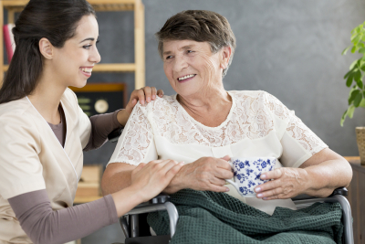 beautiful caregiver talking to a senior woman