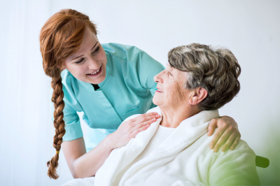 eldery woman having professional care by a caregiver