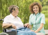 elderly woman in a wheelchair having a quality time with her caregiver